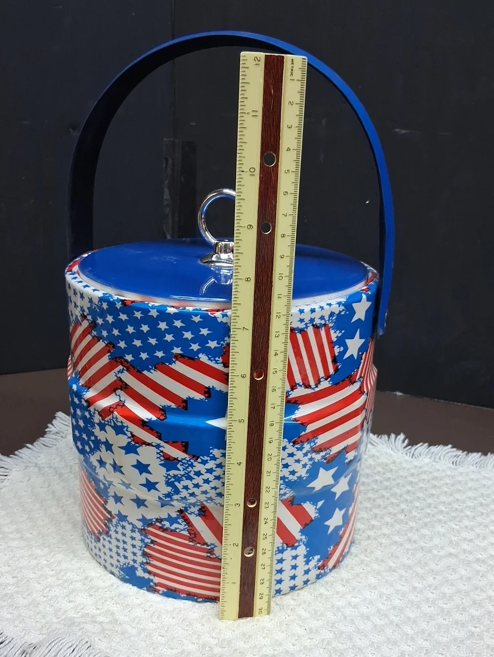 Patriotic Mr. Ice Bucket features a vibrant USA flag pattern& sturdy blue handle